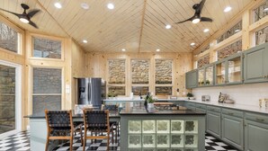 A modern kitchen with wooden walls, stone accents, and a checkered floor. - Views, Game Room, Pet-Friendly - Mountain Top Main House in Lovely Seven Devils (Seven Devils)