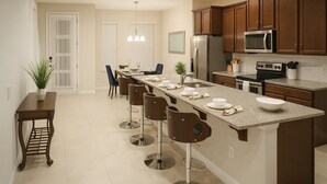 A modern kitchen with a central island, bar stools, and a dining area with chairs. - 3bd/3.5ba Retreat With Private Pool Solara Resort (Kissimmee)