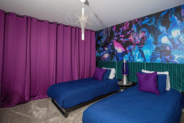 A room with two beds, purple curtains, a wall mural, and a lava lamp. - 396 - 4bd/3ba Luxurious Homechampions Gate Resort (Kissimmee)