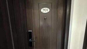 A dark wooden door with a number plate reading "701". - Skyline A : A Cozy Studio Apartment (Mumbai)