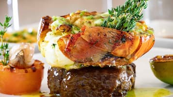 Un plat composé d’une pomme de terre au four, de viande et d’herbes aromatiques.