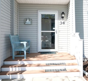 A front porch with a bench, a welcome mat, and a door with a number 34 sign. - Charming Bethany Beach Getaway Pickle Ball (Bethany Beach)