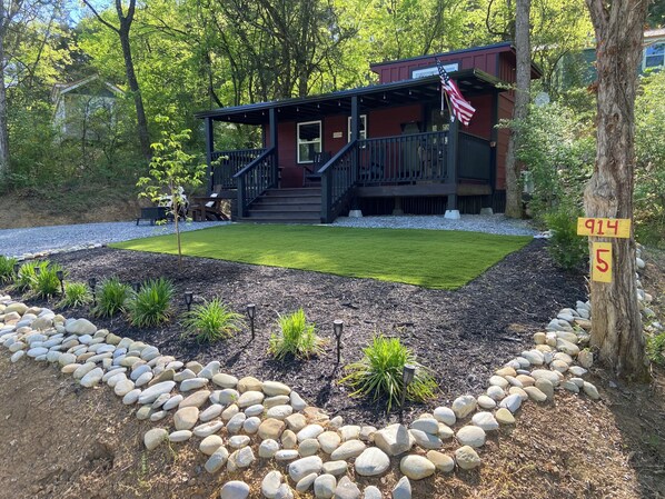 A house with a deck, a flag, and a number sign. -  Tiny Mountain Lodge with Smokey Mountain views. Newport TN Lodge decor. (Newport)