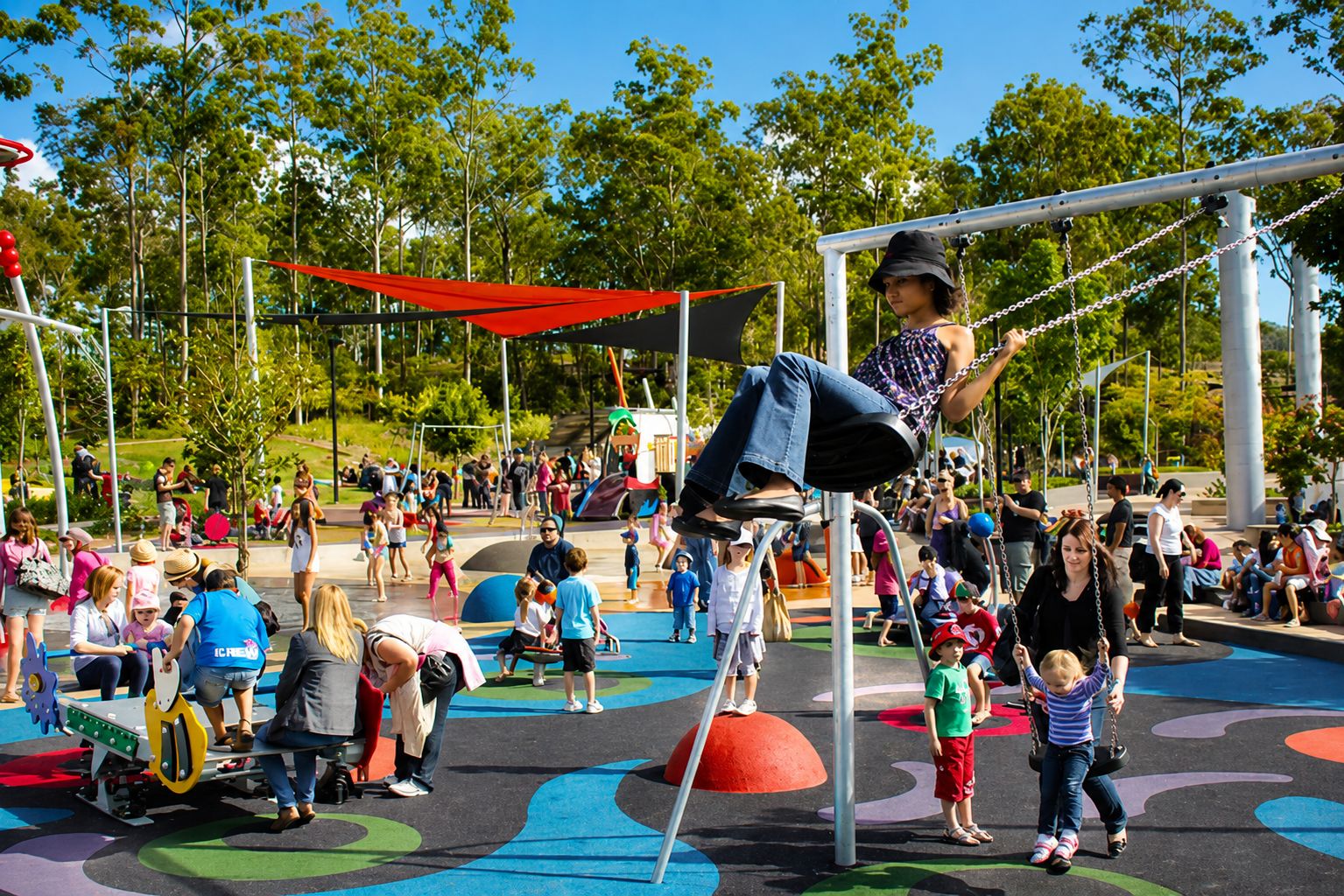 A playground with various play structures, including a swing set and climbing frames.