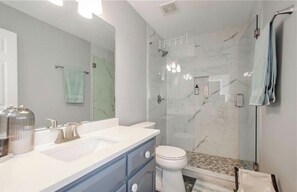 Shower, hair dryer, towels, shampoo