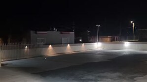 A rooftop parking area with concrete flooring and a metal fence. - Palmas View 2 (catano)