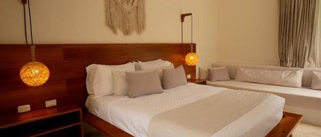Un dormitorio con una cama de madera, un sofá y un macramé colgado en la pared.