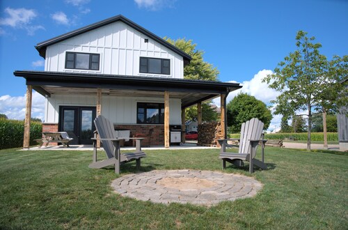 Cozy modern 2-bedroom farmhouse suite w/ clawfoot tub, firepit & country views.