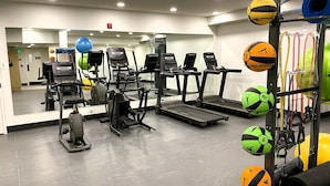 A gym with treadmills, ellipticals, and a variety of exercise balls. - 🥇 Black Bears Den, Heated Pool, Hot Tub, Brand NEW! (Canmore)