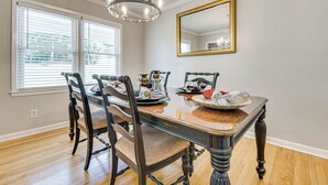 A dining room with a wooden table, chairs, and a chandelier. - 3 Mi to Arabia Mtn Trails: Quiet Ranch-Style Home (Stonecrest)