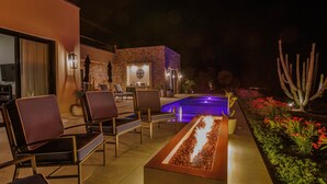 An outdoor seating area with chairs and a fire feature. - Escape to Cabo Luxury at Las Terrazas #05 (Cabo San Lucas)