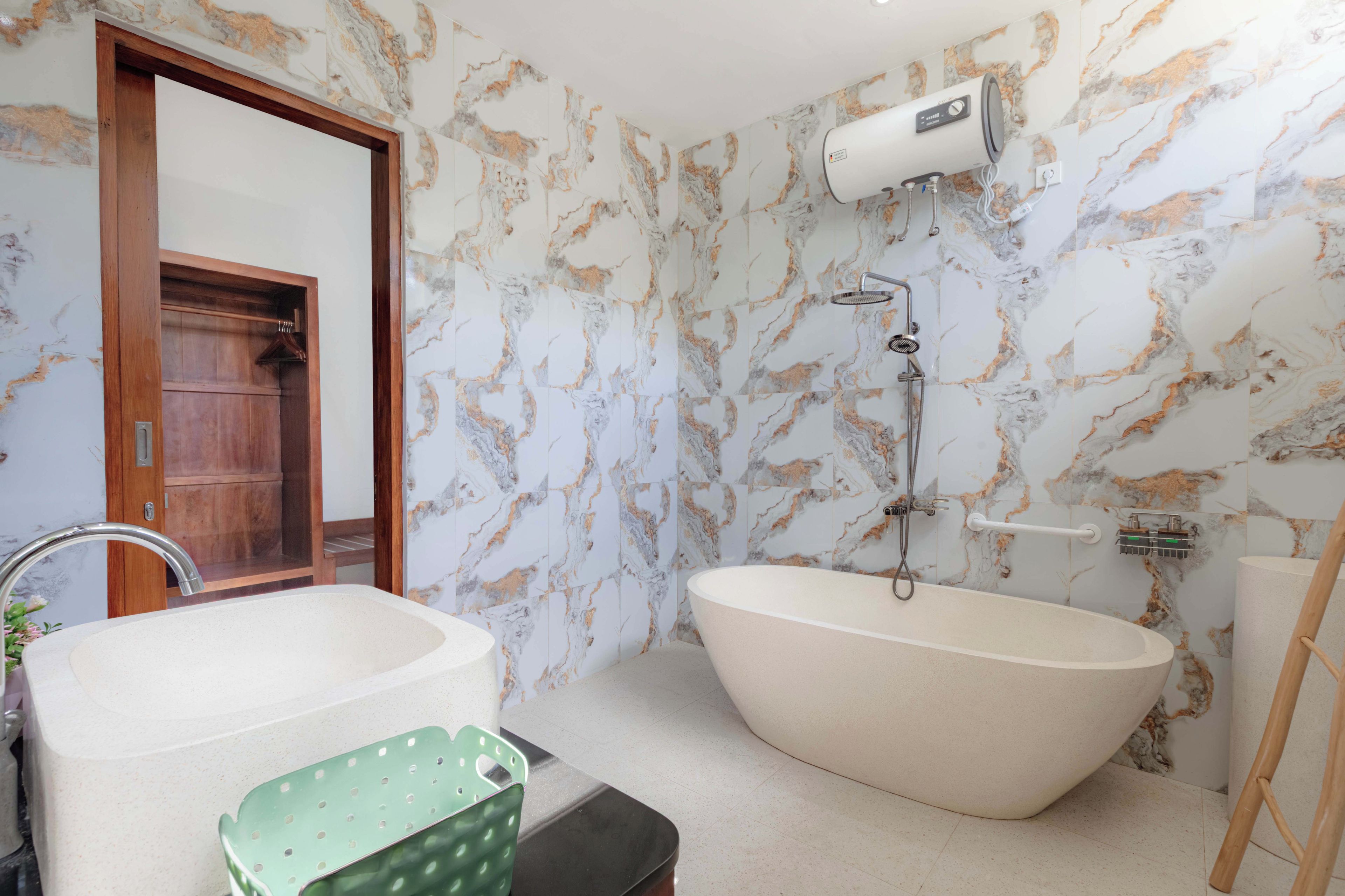 A bathroom with a freestanding bathtub, a shower, and a wooden door.