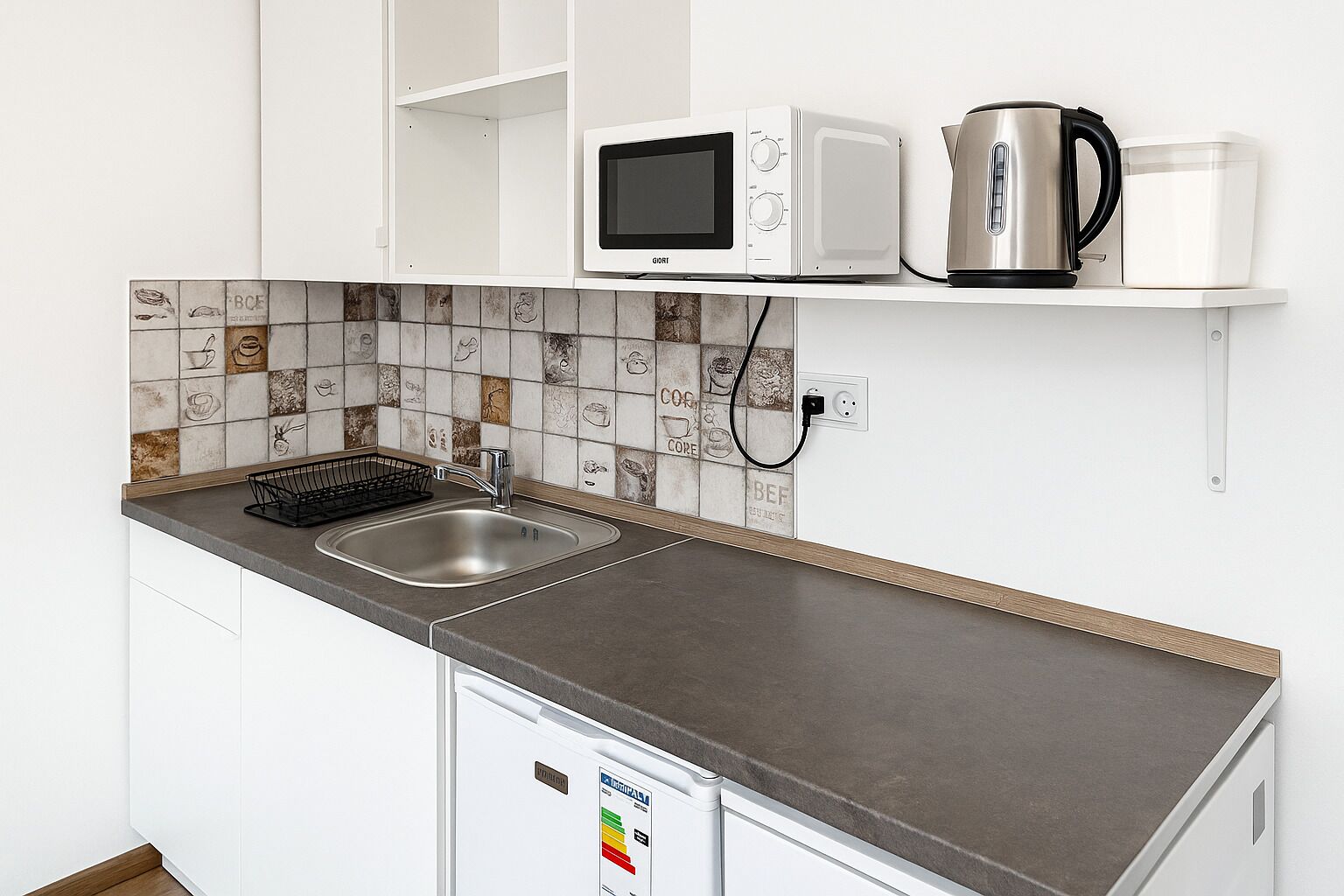 Een koelkast, een magnetron, een kookplaat, kookgerei, borden en bestek