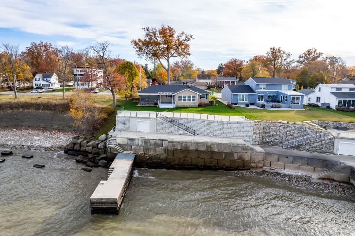 A residential area with houses, a dock, and a river.