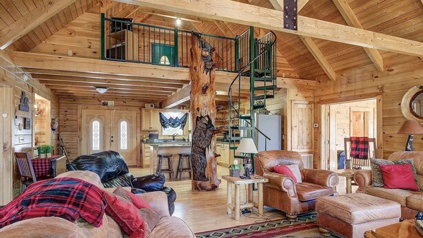 A spacious log cabin interior with a loft bedroom, a dining area, and a kitchen. - Skyline Lodge, beautiful lodge home with mountain and lake view (Butler)