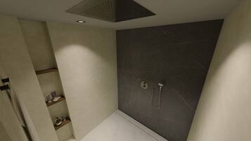 Un baño moderno con ducha, inodoro y lavabo.