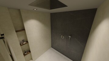 Un baño moderno con ducha, inodoro y lavabo.