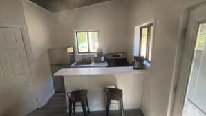 A kitchen with a window, a microwave, and a small cabinet. - perfect studio, few minutes away to the heart of new Paltz & Mohonk Mountain (New Paltz)