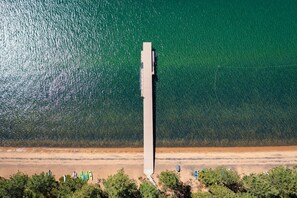 A coastal area with a tall structure, possibly a pier, extending into the water. - Pinewild Retreat | Sauna, Decks & Beach | Sleeps 6 (Zephyr Cove)