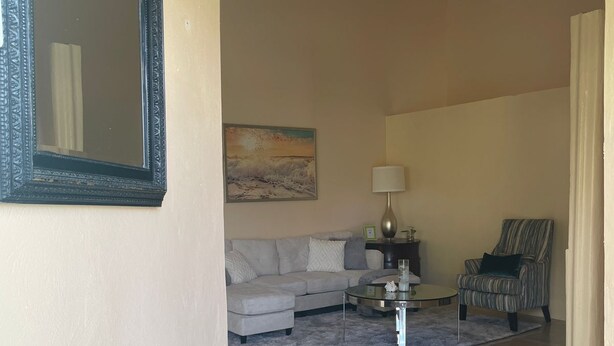 A living room with a sofa, a coffee table, a lamp, and a chair. - Hibiscus Apartment Lovely 2-bedroom apartment with AC in Gros Islet/Corinth (Gros Islet)