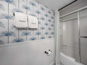 Shower, hair dryer, towels, shampoo