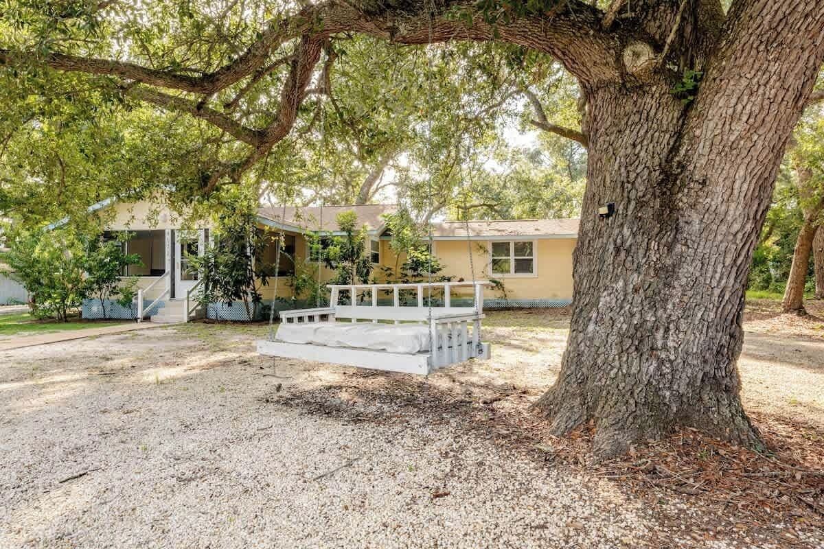 Unwind under the shade of a majestic oak tree and sway gently on the oversized porch swing. This peaceful outdoor spot is perfect for morning coffee, quiet reading, or simply soaking in the charm of the property.