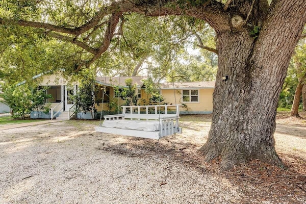 Unwind under the shade of a majestic oak tree and sway gently on the oversized porch swing. This peaceful outdoor spot is perfect for morning coffee, quiet reading, or simply soaking in the charm of the property.