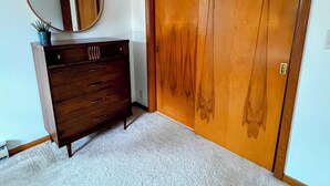 A room with a wooden wardrobe, a dresser, and a mirror. - Spacious 3BR 2BA Gem Close to Downtown, 30 day min (Eau Claire)