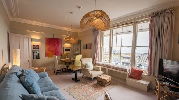 A cozy living room with a sofa, a dining table, and a TV. - 11b Market Cross Place, Aldeburgh (Aldeburgh)