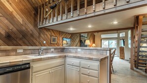A kitchen with a dishwasher, white cabinets, and a wooden ceiling. - 3 Bedrooms + Loft townhome in Snowcreek Phase 3,  Private Pool Table Sleeps 6 Guests, Dog Friendly (Mammoth Lakes)