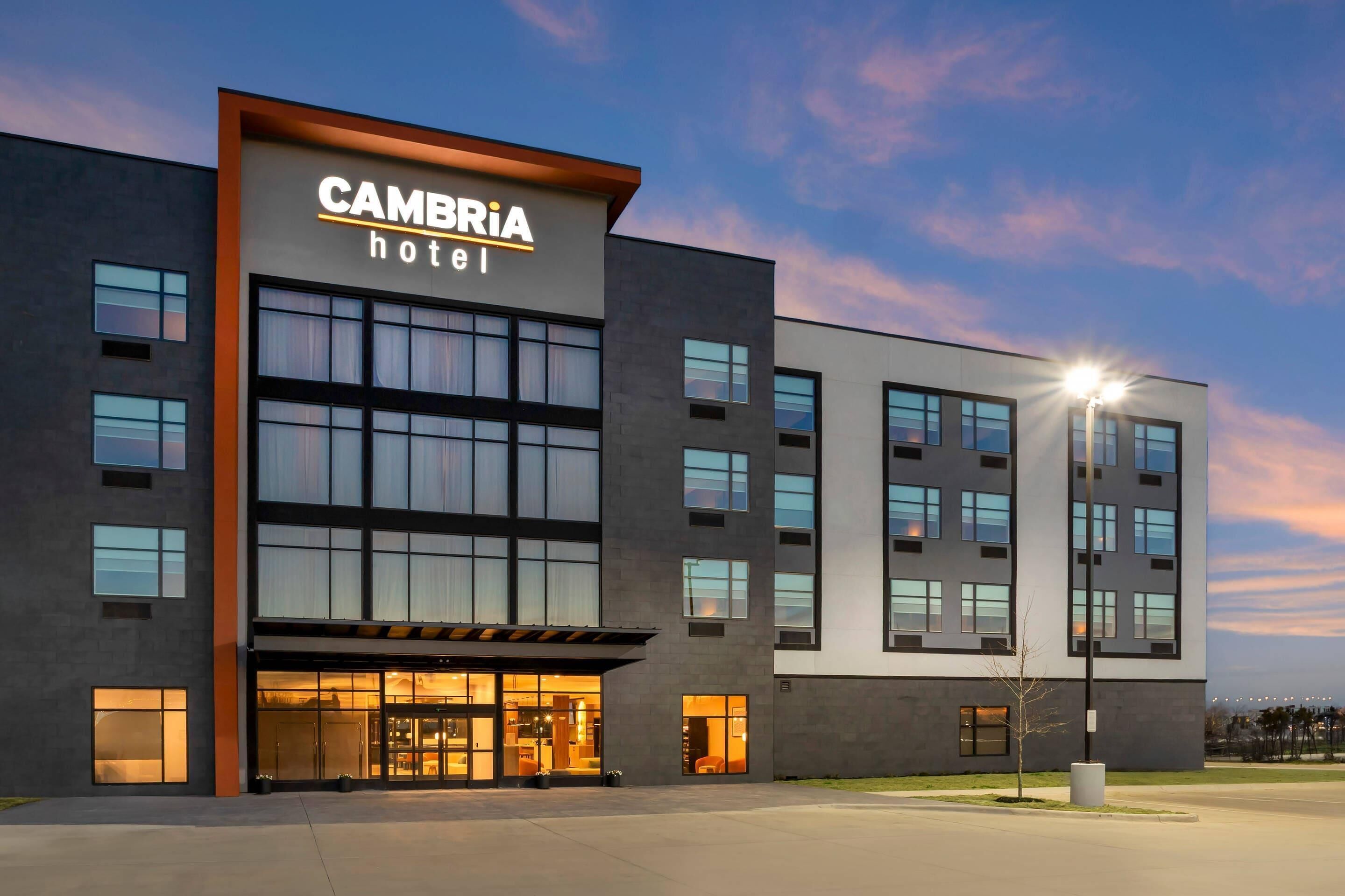 A modern hotel building with a prominent sign reading 'CAMBRIA hotel.'