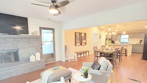 A spacious living room with a fireplace, a dining area, and a kitchen. - Tulsa Expo Luxury Stay - 1 mi to Expo (Tulsa)