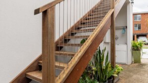 A wooden staircase with metal railings leading to an upper floor. - The Jitterbug - Sleeping 4 Guests (The Hill)