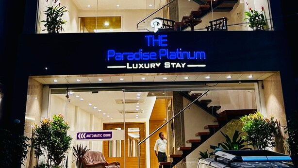 A multi-story building with a sign reading "The Paradise Platinum Luxury Stay." - THE PARADISE PLATINUM (Kanchipuram)