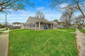 A single-story house with a front porch, a small attached garage, and a well-maintained lawn.