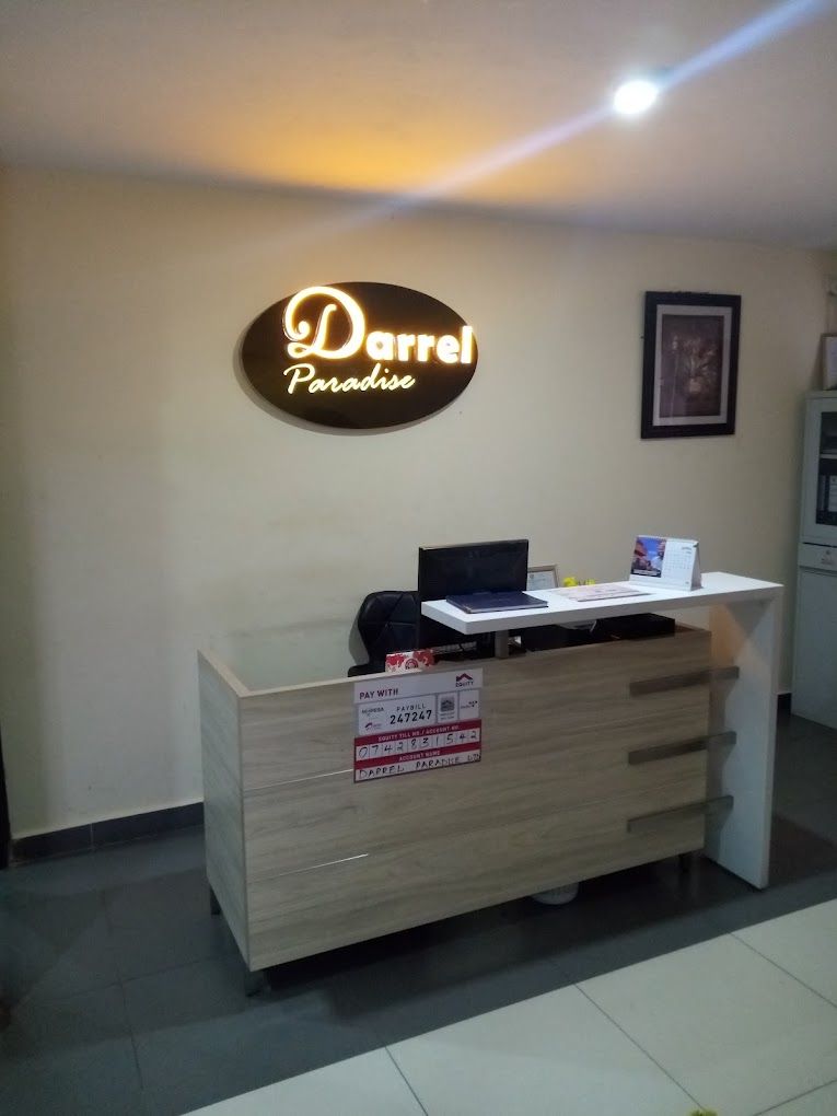 A reception desk with a sign that reads "Darrel Paradise."