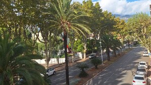A tree-lined street with parked cars and a clear sky. - Seaside in Menton.2 rooms with balcony and parking. (Menton)