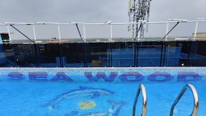 A pool with a blue mosaic design and the words "SEA WOOD" on the floor. - Hotel Sea Wood (Digha)