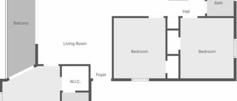 Plano de planta que muestra un balcón, comedor, cocina, cuarto de servicio, baño, sala de estar, dos dormitorios, vestíbulo y armario de doble entrada.