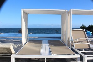 Seasonal outdoor pool, open 9:00 AM to 8:00 PM, pool umbrellas