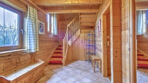 A wooden interior with a bench, a staircase, and a window. - Scenic Stay in Feriendorf Wildschönau Chalet (Wildschönau)
