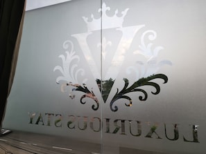 A glass window with a logo and the name "LUXURIOUS" visible.