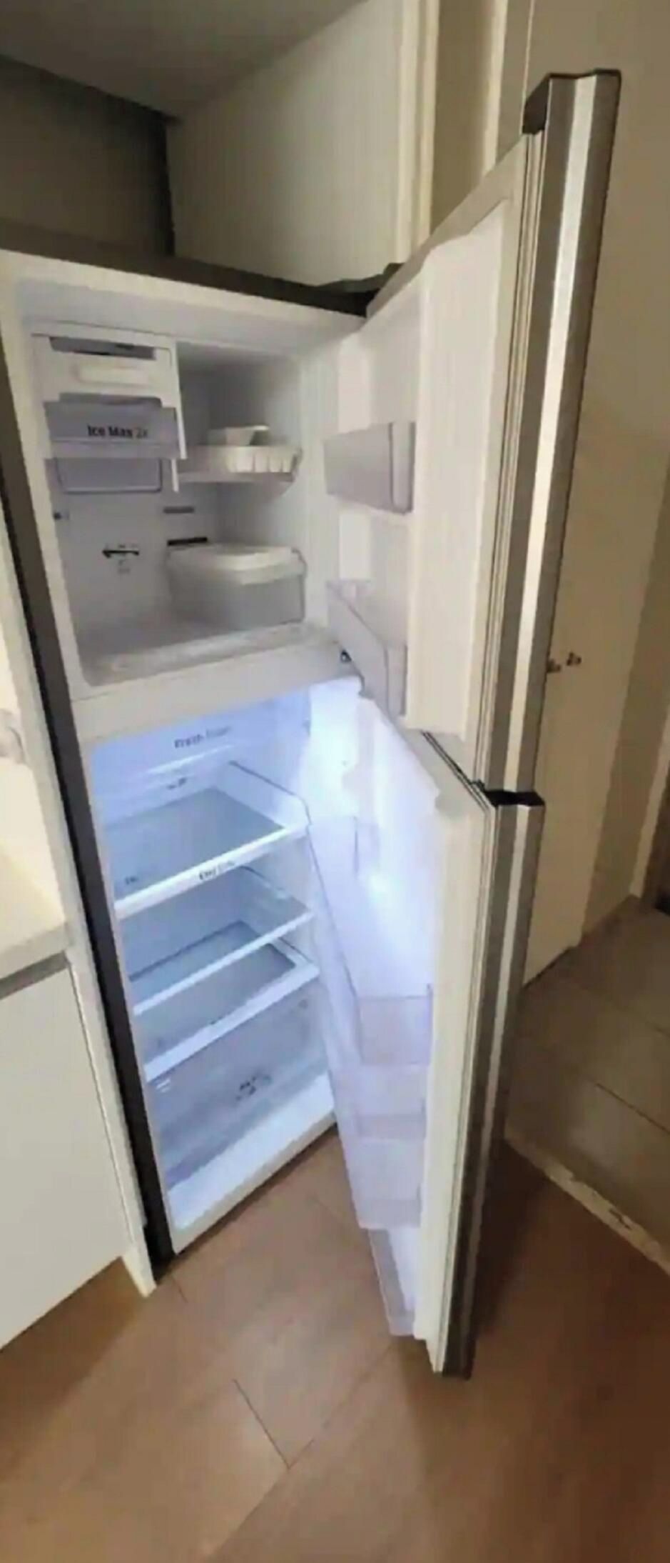 An open refrigerator with multiple shelves and a freezer compartment.