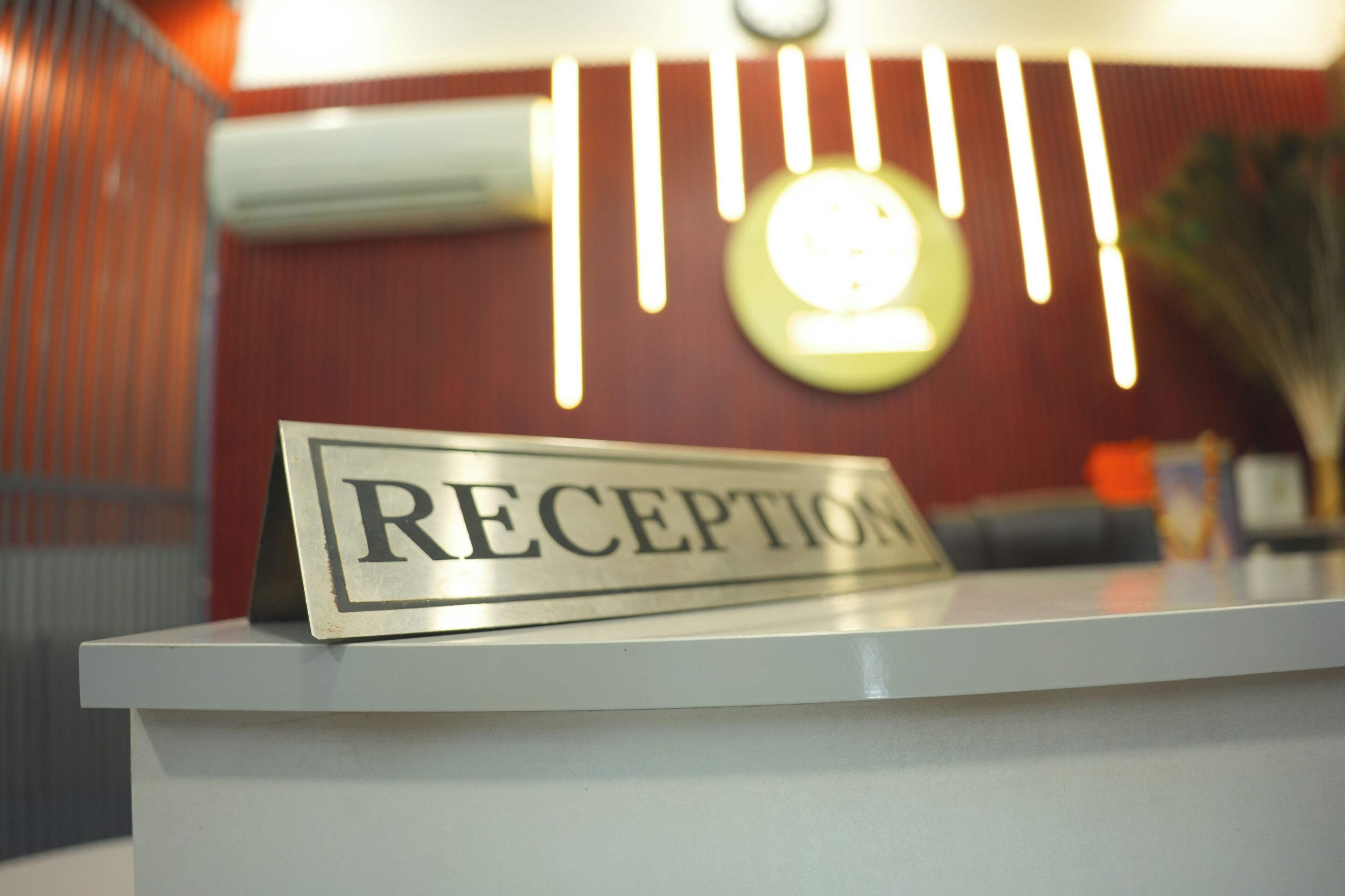 A reception desk with a sign that reads "RECEPTION".