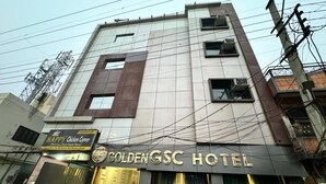 The exterior of the GoldenGSC Hotel with a signboard indicating it is a chicken restaurant. - GOLDEN GSC HOTEL (Amritsar)