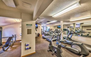 A gym with treadmills, elliptical machines, and weight equipment.