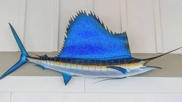 A large, detailed sculpture of a fish, possibly a sailfish, mounted on a wall.