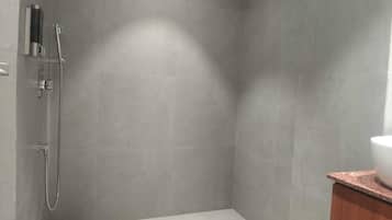 Shower, hair dryer, slippers, towels