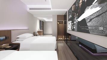 A modern hotel room with two beds, a desk, a wardrobe, and a large TV screen displaying a movie.