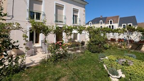 A two-story house with a garden in front.